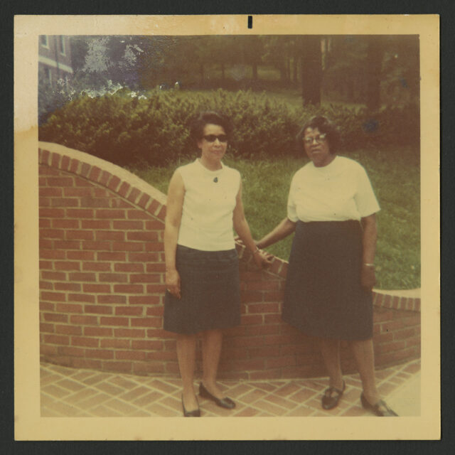 Venus Jones' mother, Bessie Reid Jones, and her paternal grandmother, Alice Jones, pose together in front of a brick wall on the campus of MWC (Mary Washington College).