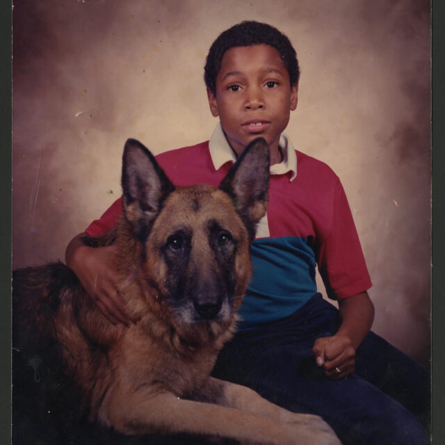 Hannibal Reid, who Venus Jones helped to raise and mentor, poses for a picture with a German Shepherd.