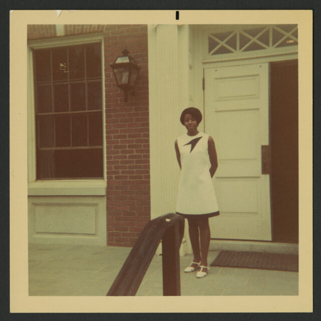Venus Jones poses for a photo in front of a building's entrance on MWC's campus.
